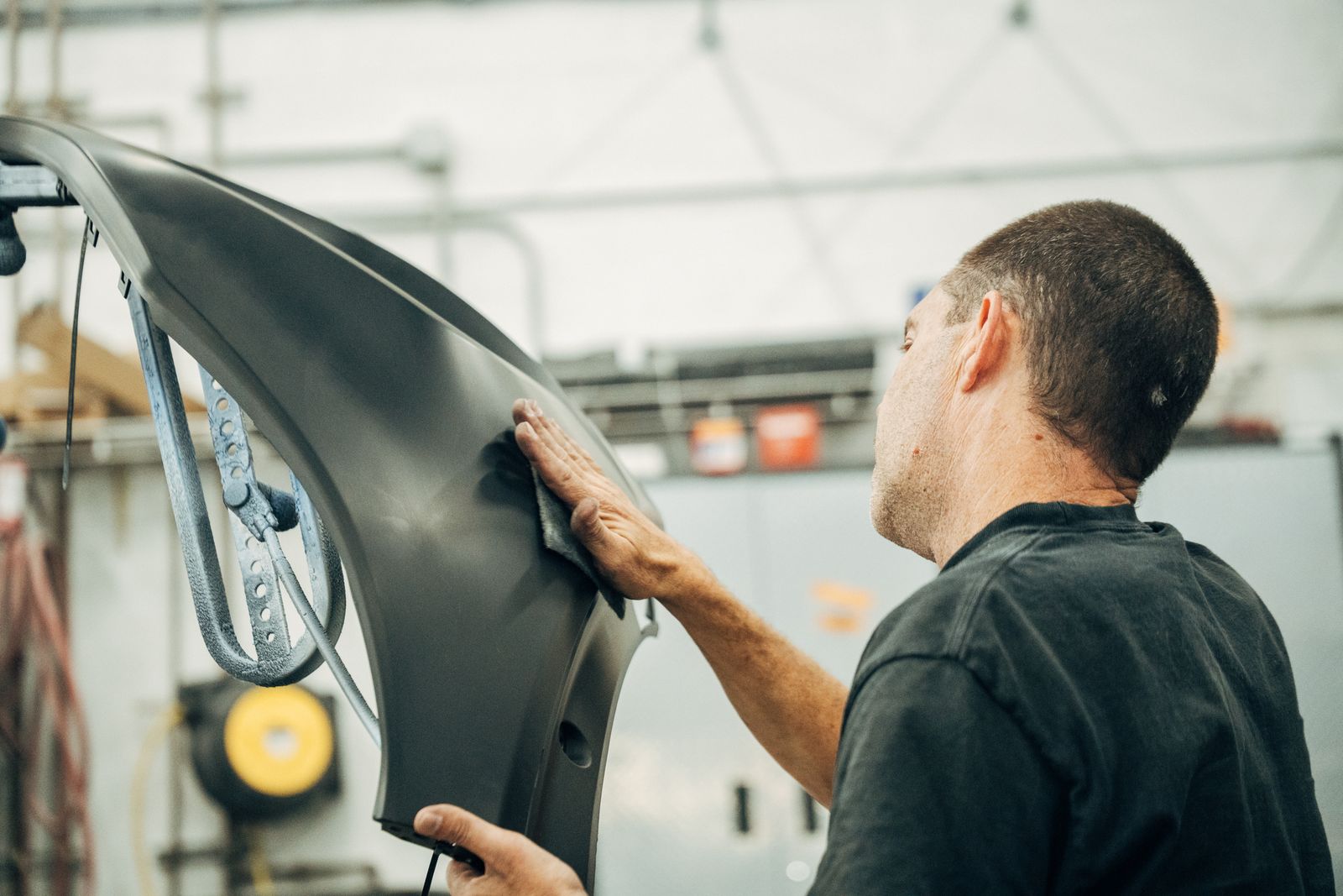 Technician prepping a bumper cover