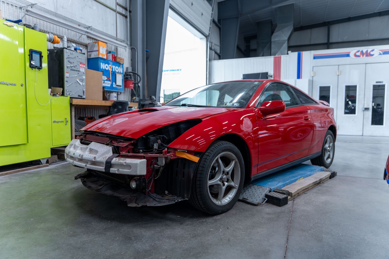 Red car with front-end collision damage