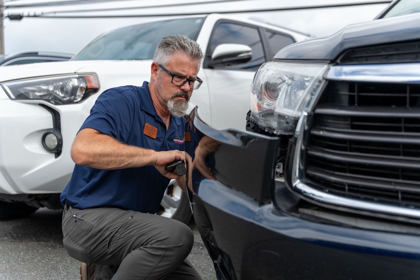 Estimator checking front-end damage on a Toyota Tundra