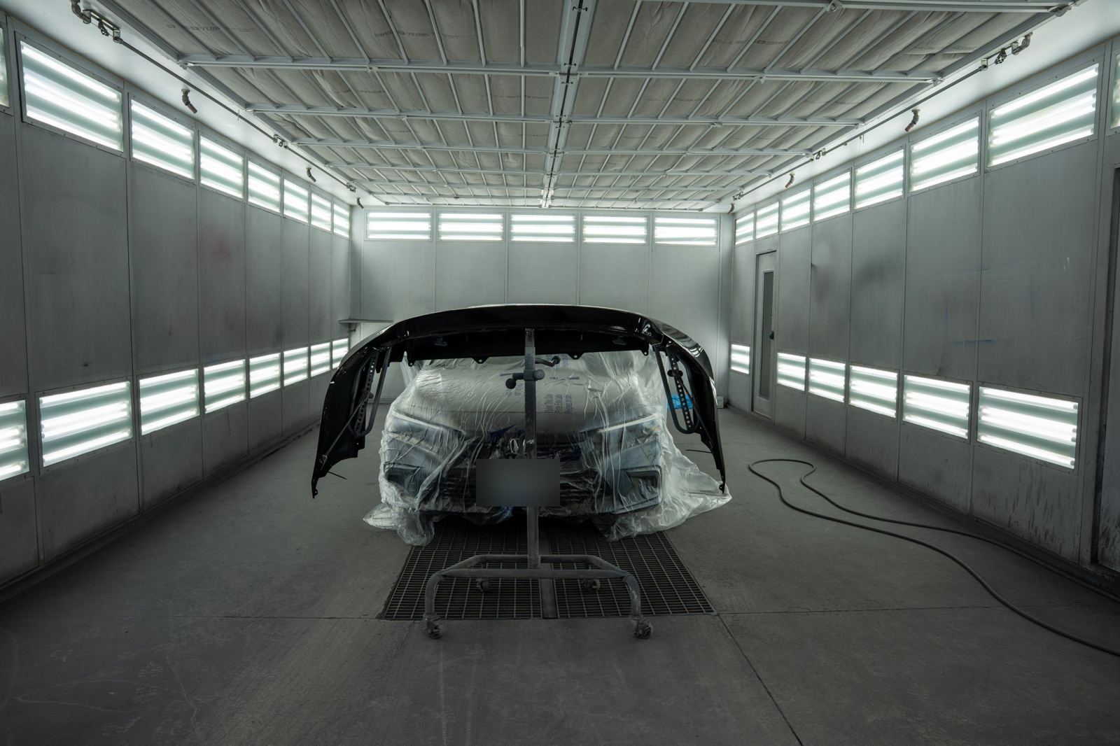 Bumper cover being painted in the paint booth